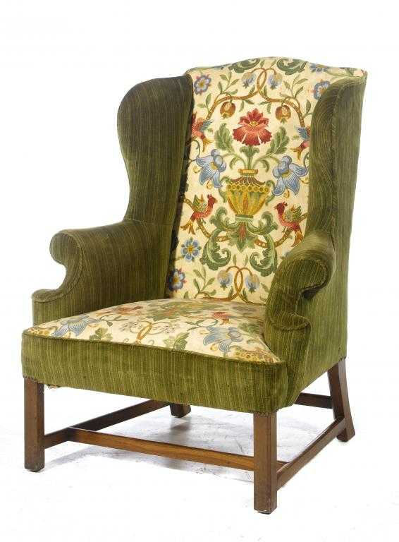 A MAHOGANY ARMCHAIR with wing back and overscrolled arms upholstered