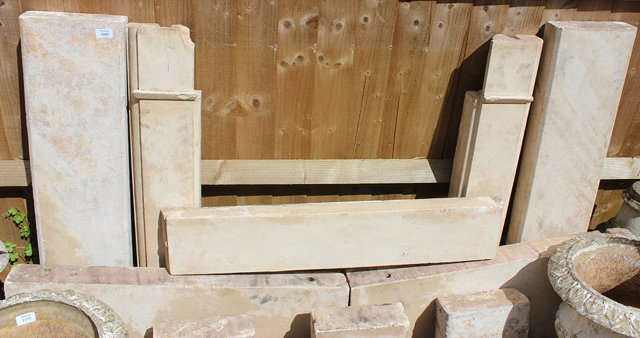 A COTSWOLD STONE FIRE SURROUND of shallow arch form standing