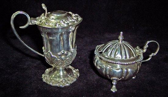 A circular moulded mustard pot with hinged cover and scroll