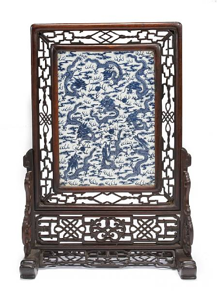 A large blue and white porcelain and wood table screen