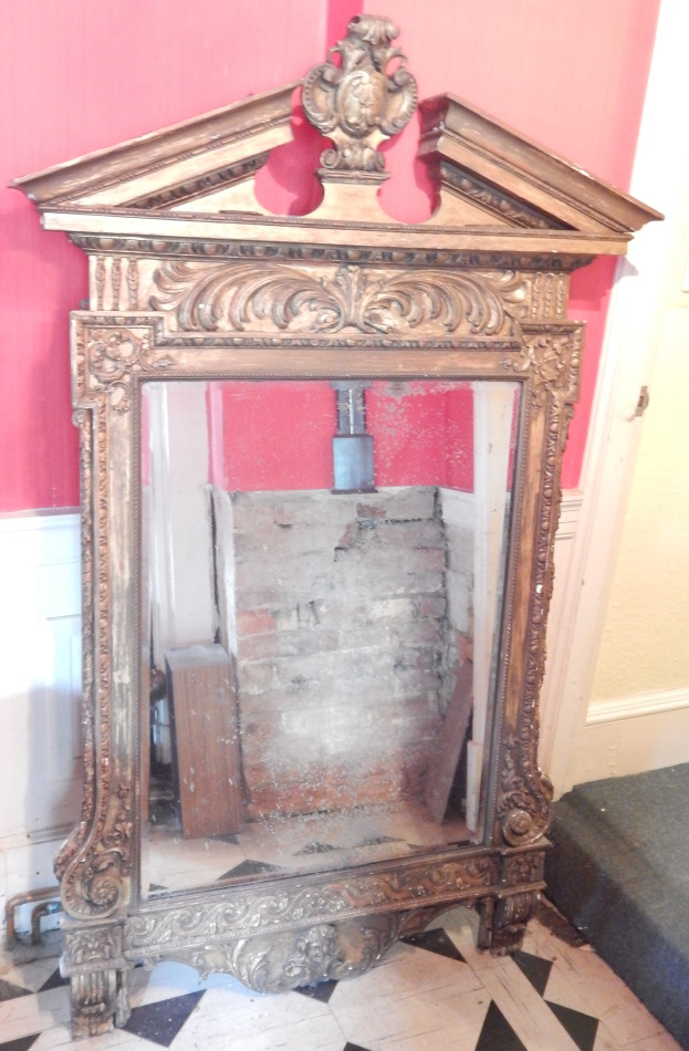 A 19thC gilt gesso wall mirror the broken pediment with