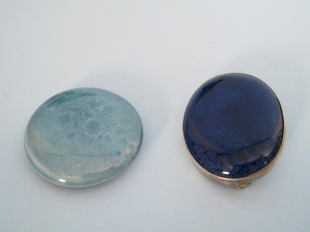 A Ruskin Brooch the oval royal blue enamel plaque impressed