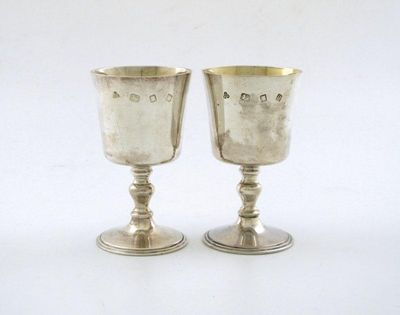 A pair of modern silver goblets tapering circular bowls on