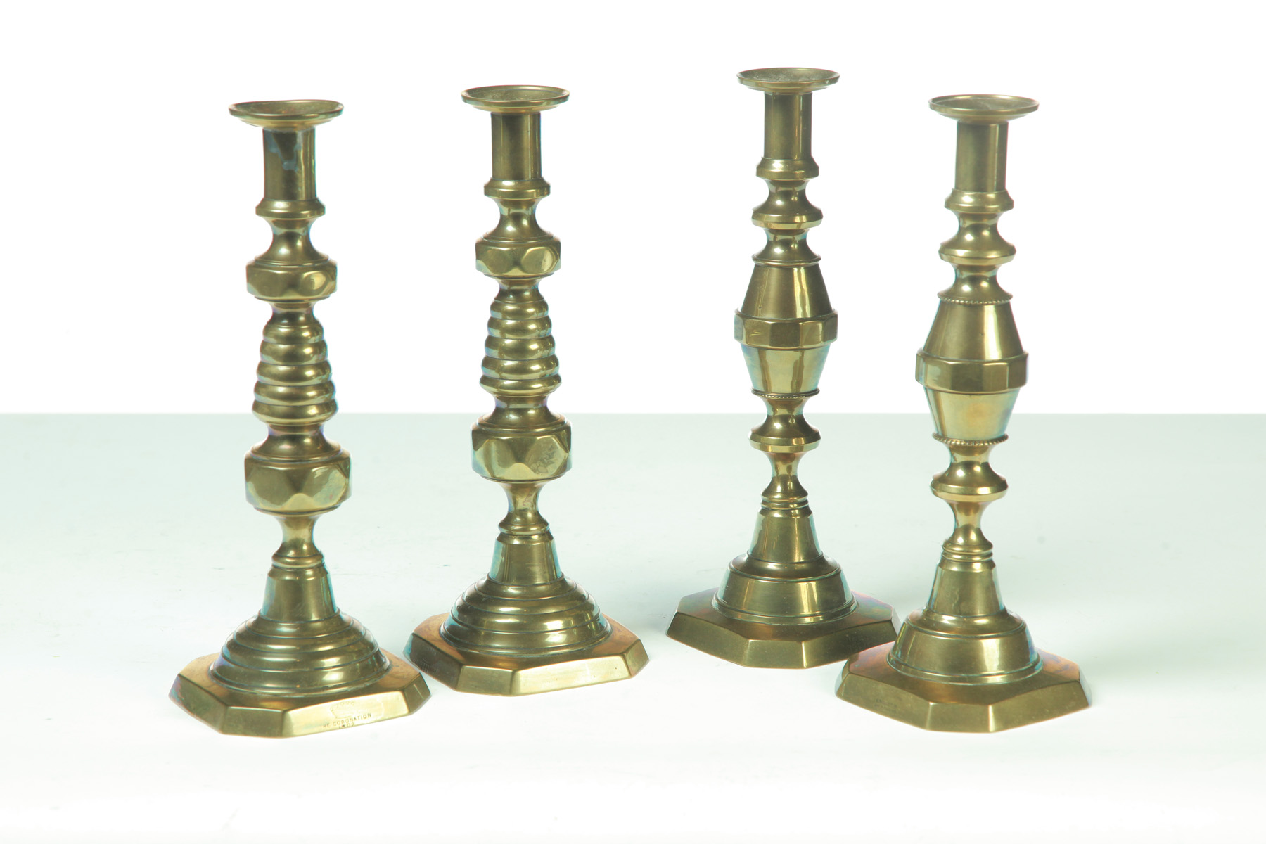 TWO PAIRS OF BRASS PUSH UP CANDLESTICKS England Nicely cast