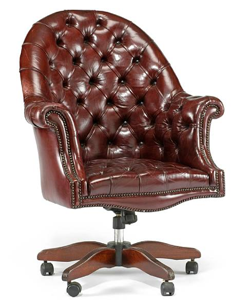 A Victorian style tufted burgundy leather desk chair The arched
