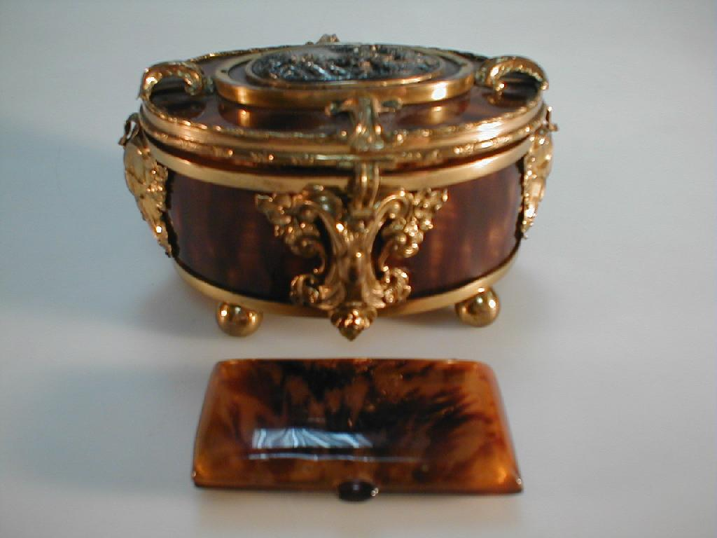 A cast brass and faux tortoiseshell casket of oval form