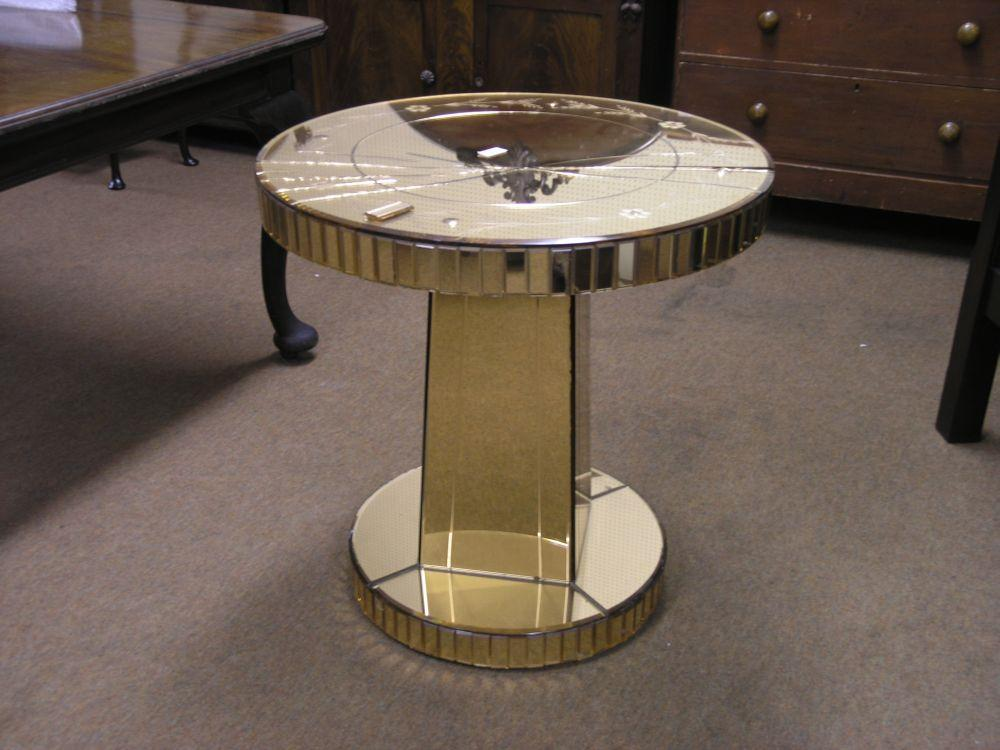 An Art Deco peach coloured glass dressing table circular top