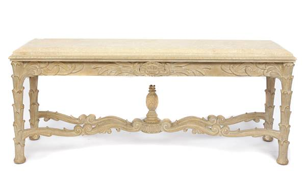 A large carved pickled oak console table with limestone top
