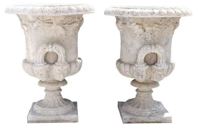pair Cast stone campana form garden urns 20thc featuring egg