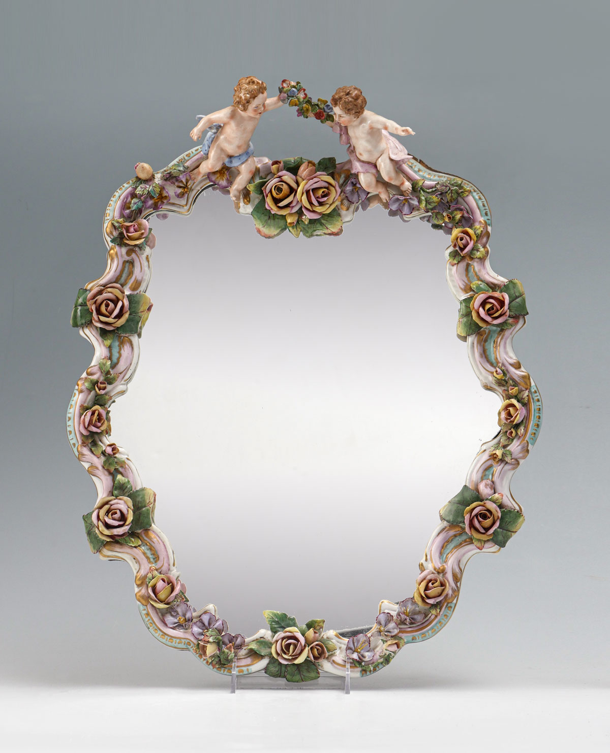 MEISSEN STYLE PORCELAIN MIRROR Surmounting cherubs with bouquets Porcelain segmented