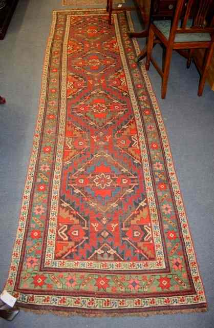 A PERSIAN RUNNER the central rectangular field filled with four