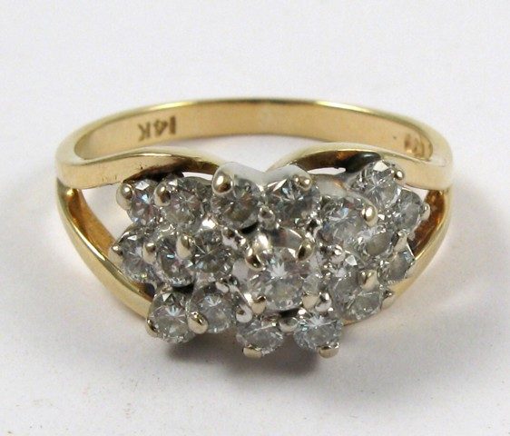 DIAMOND AND FOURTEEN KARAT GOLD RING set with a cluster