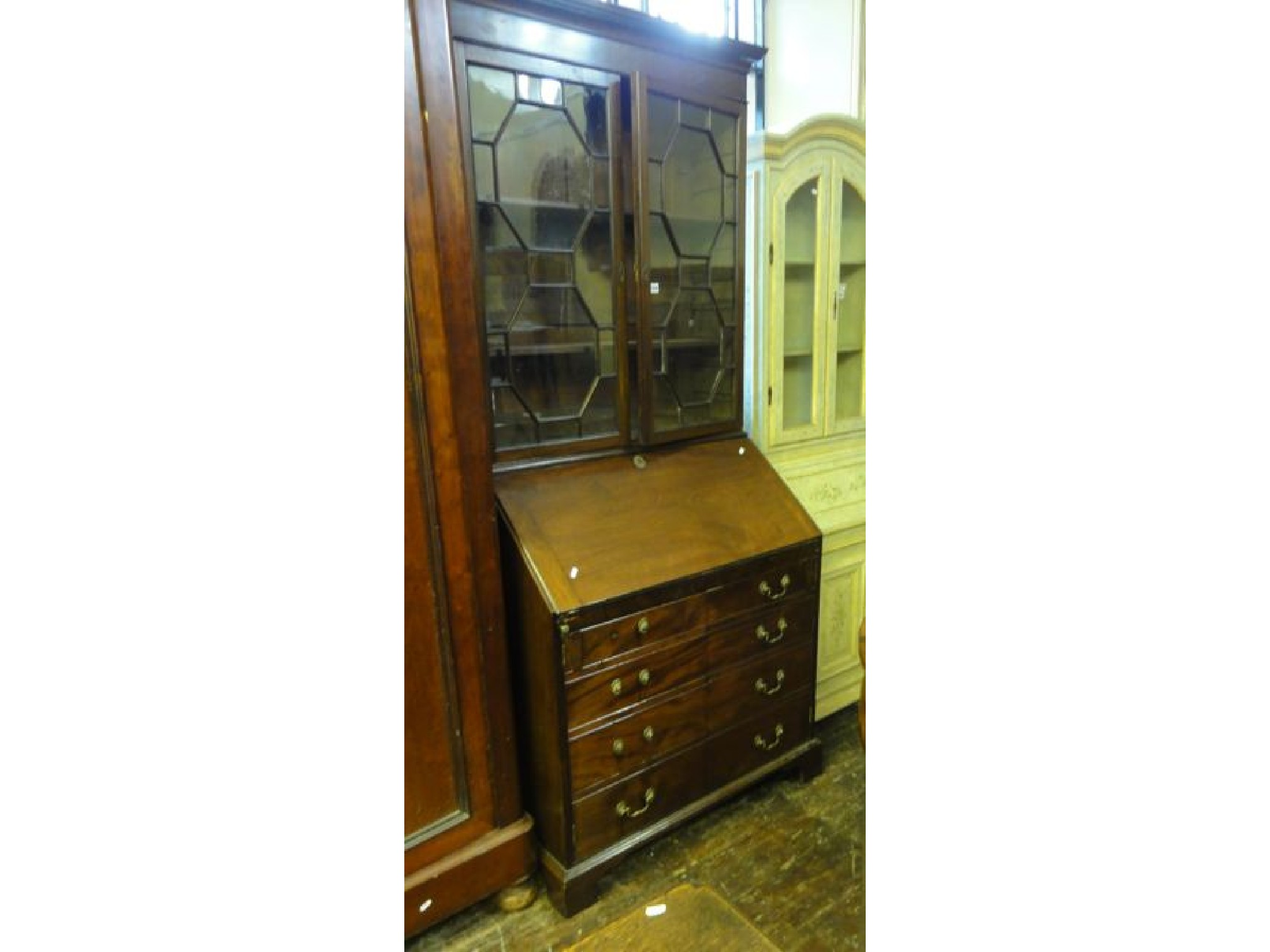 A Georgian mahogany bureau bookcase the upper section with moulded