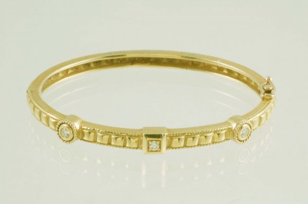 Diamond bangle bracelet in marked 18K yellow gold Two 10