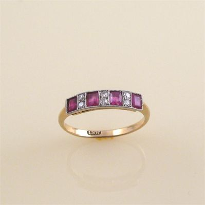 A ruby and diamond half hoop ring alternately set with