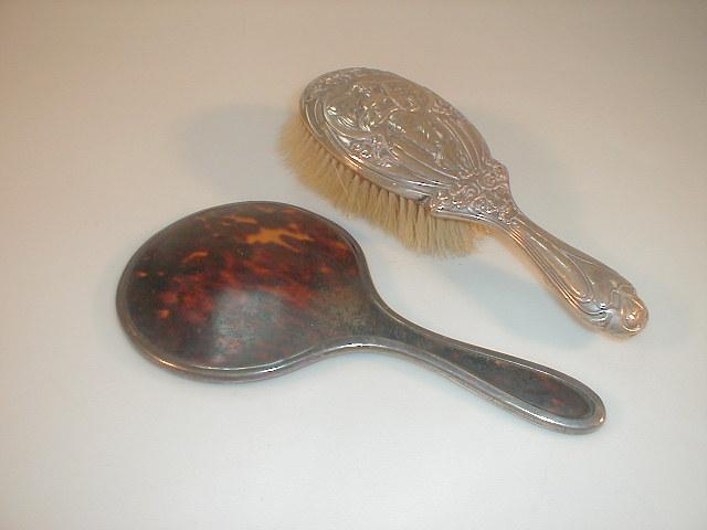 An Edward VII silver backed hair brush embossed in the