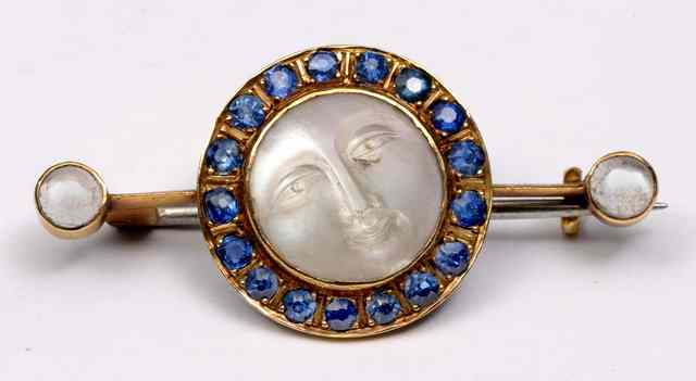 A MOONSTONE AND SAPPHIRE BROOCH central Man in the Moon