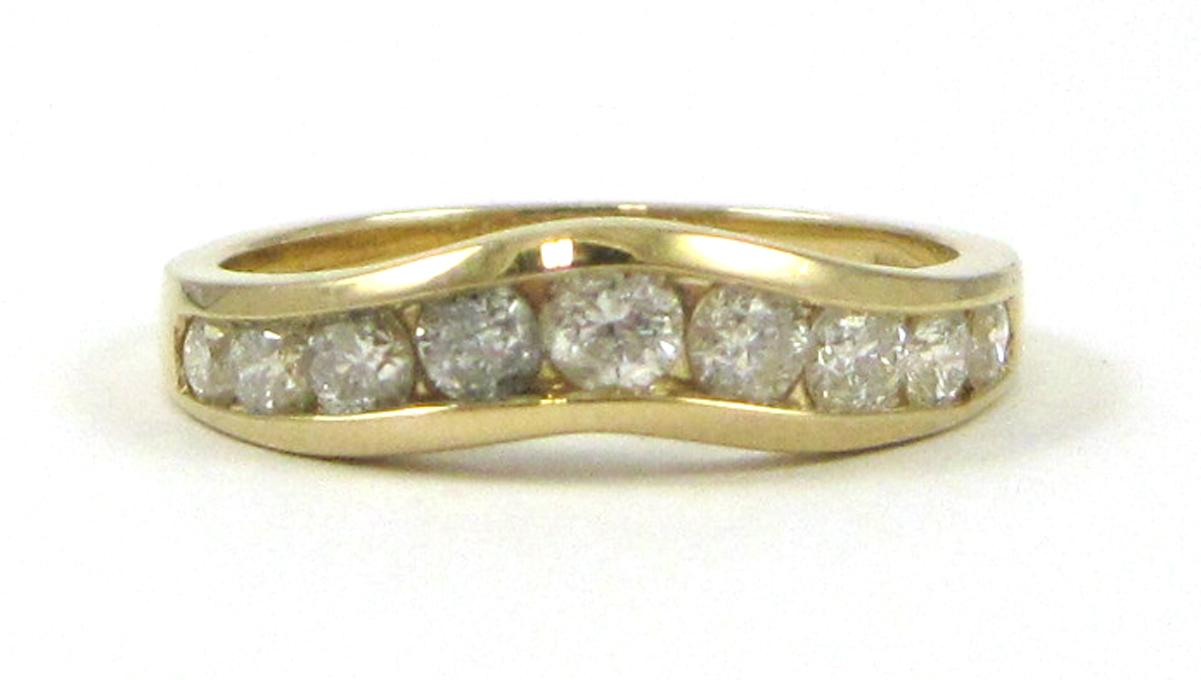 DIAMOND AND FOURTEEN KARAT GOLD CHEVRON RING channel set with