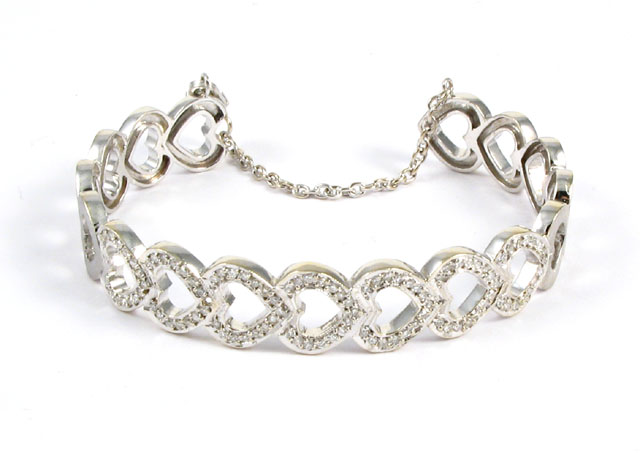 DIAMOND AND EIGHTEEN KARAT GOLD BANGLE the top covered with