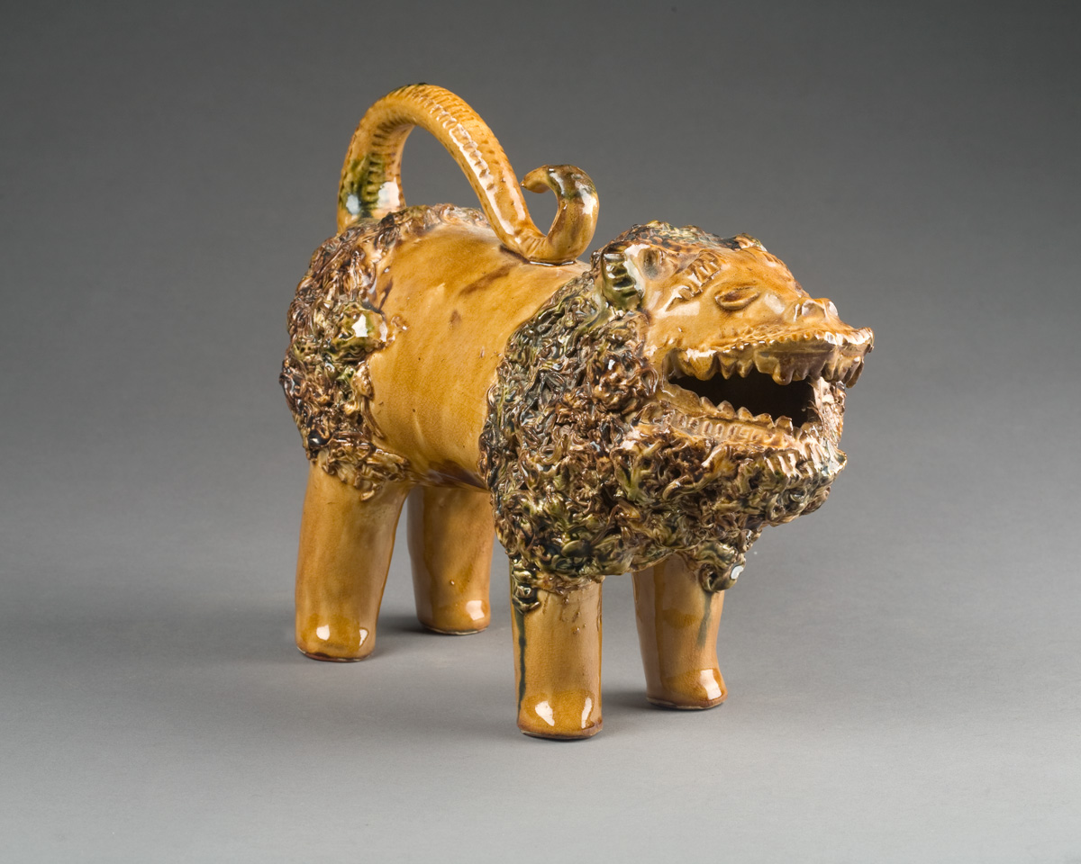 REPRODUCTION SHENANDOAH POTTERY FIGURE OF A SNARLING LION Modelled standing