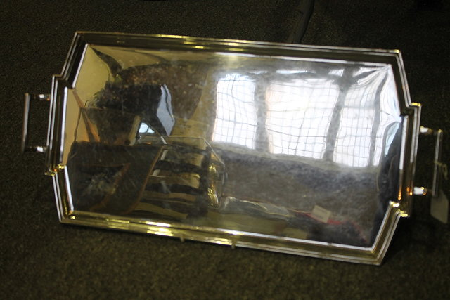 A SILVER TRAY of shaped rectangular form with raised border