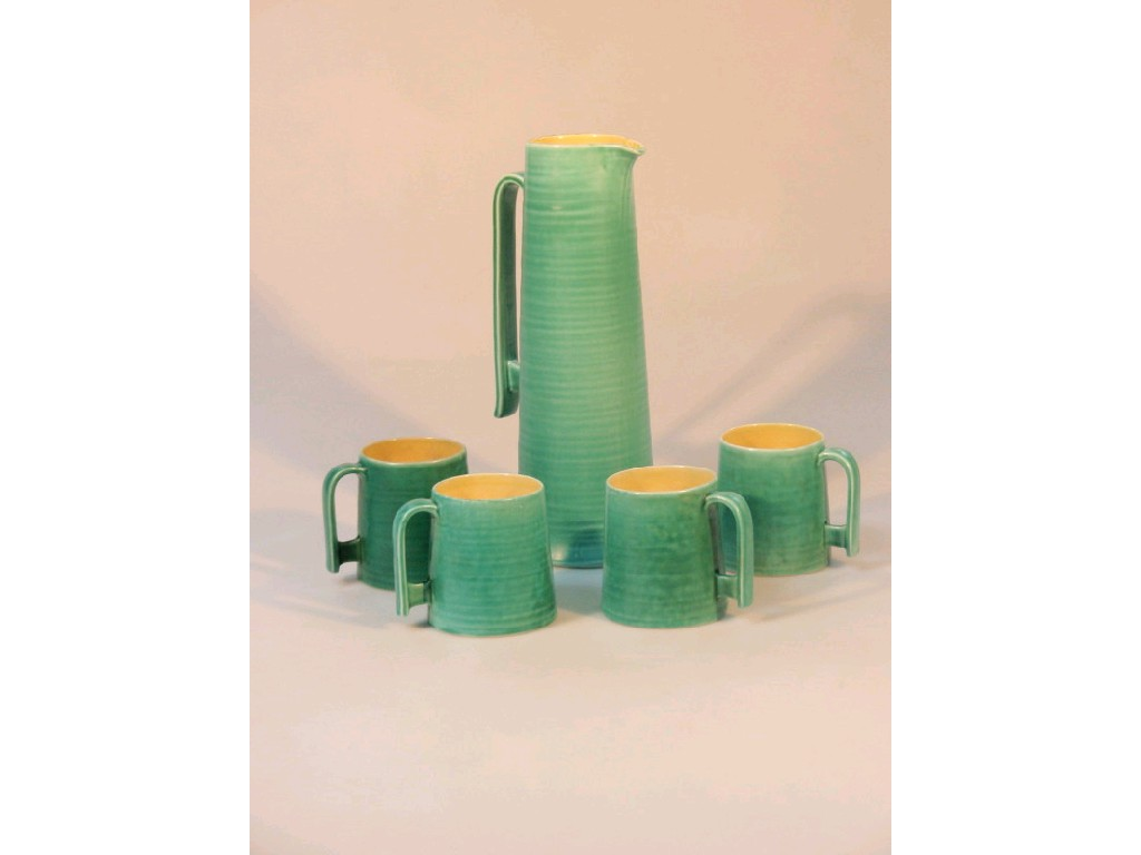 A Bretby pottery jug of tall tapering form with a