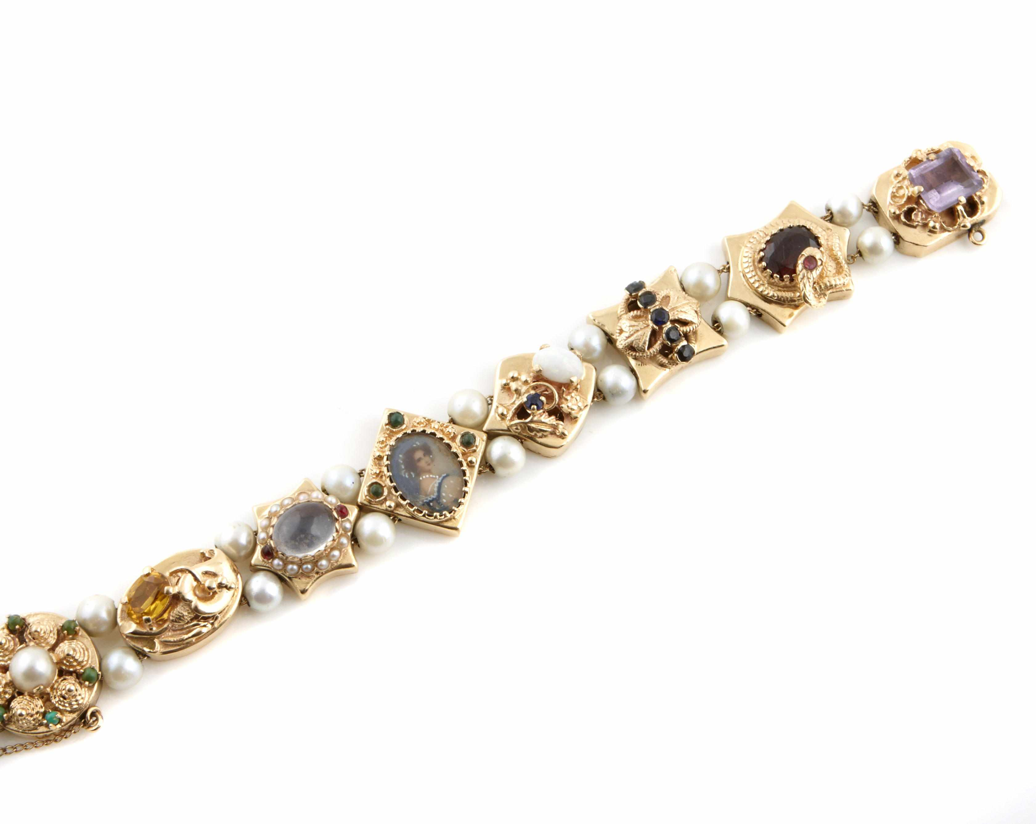 A gem set slide bracelet designed as 8 slides interspaced