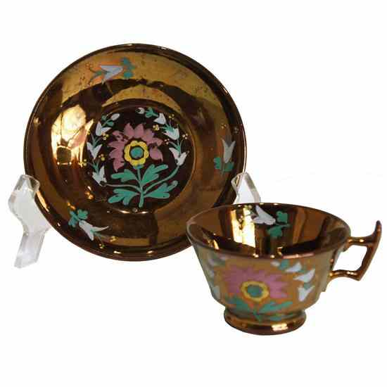 An English Copper Lustre Cup and Saucer circa 1840 having