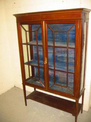 AN EDWARDIAN MAHOGANY DISPLAY CABINET of oblong form with stringing