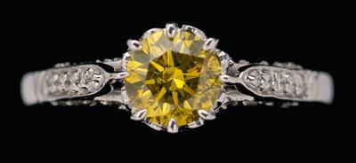 Fancy yellow diamond ring central round brilliant cut diamond estimated