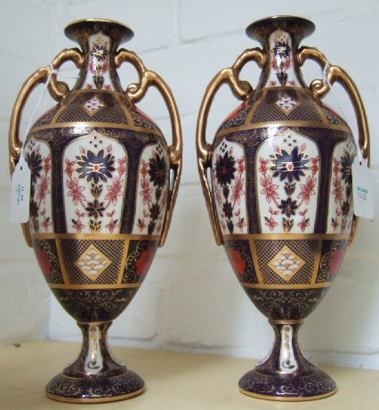 A pair of Royal Crown Derby two handle vases last