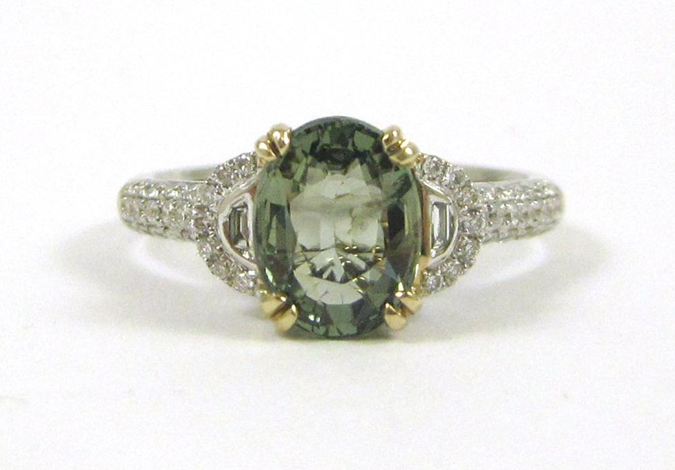 GREEN SAPPHIRE AND FOURTEEN KARAT GOLD RING The white gold
