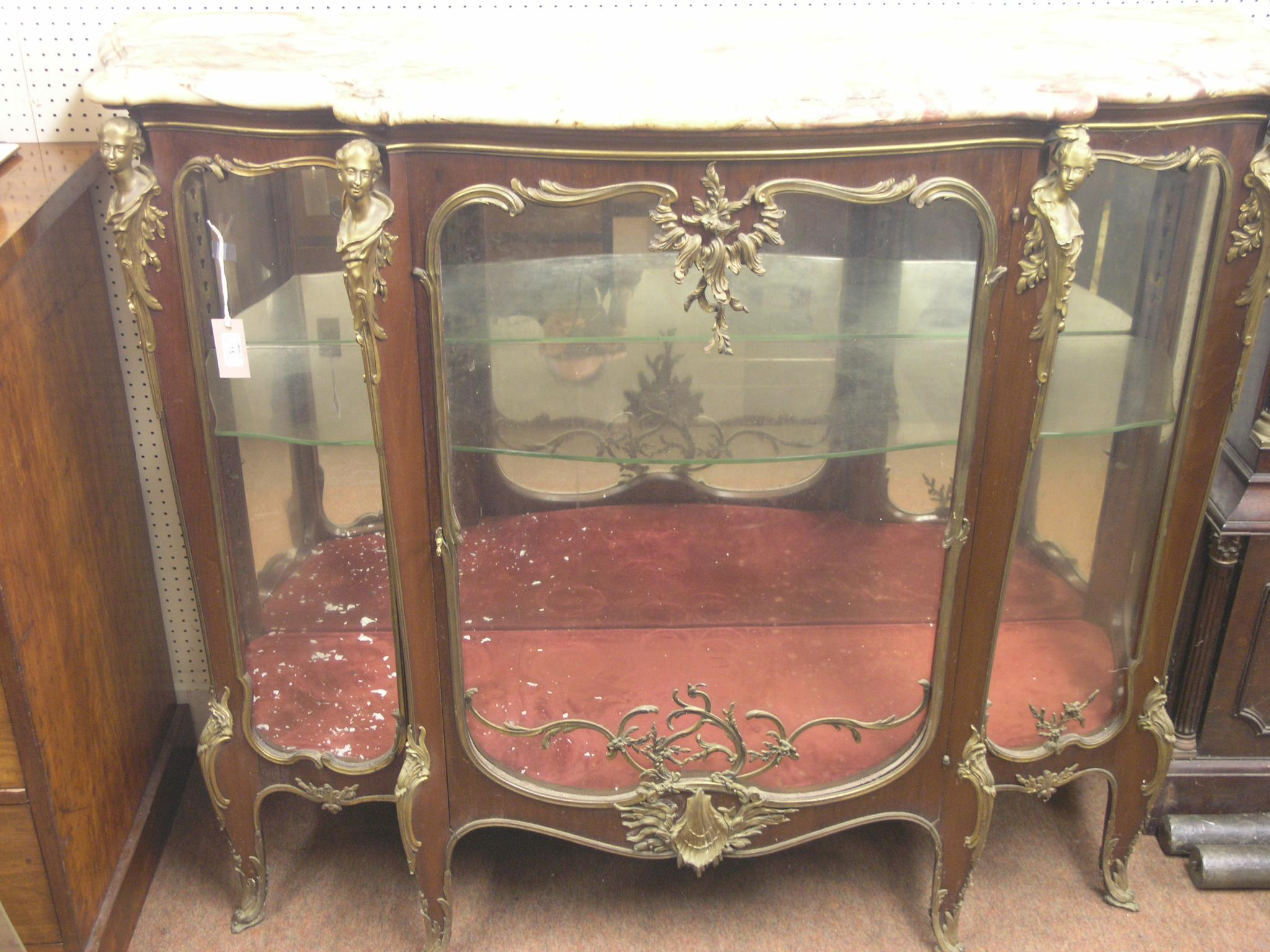 A large Louis XV style mahogany display cabinet serpentine shape