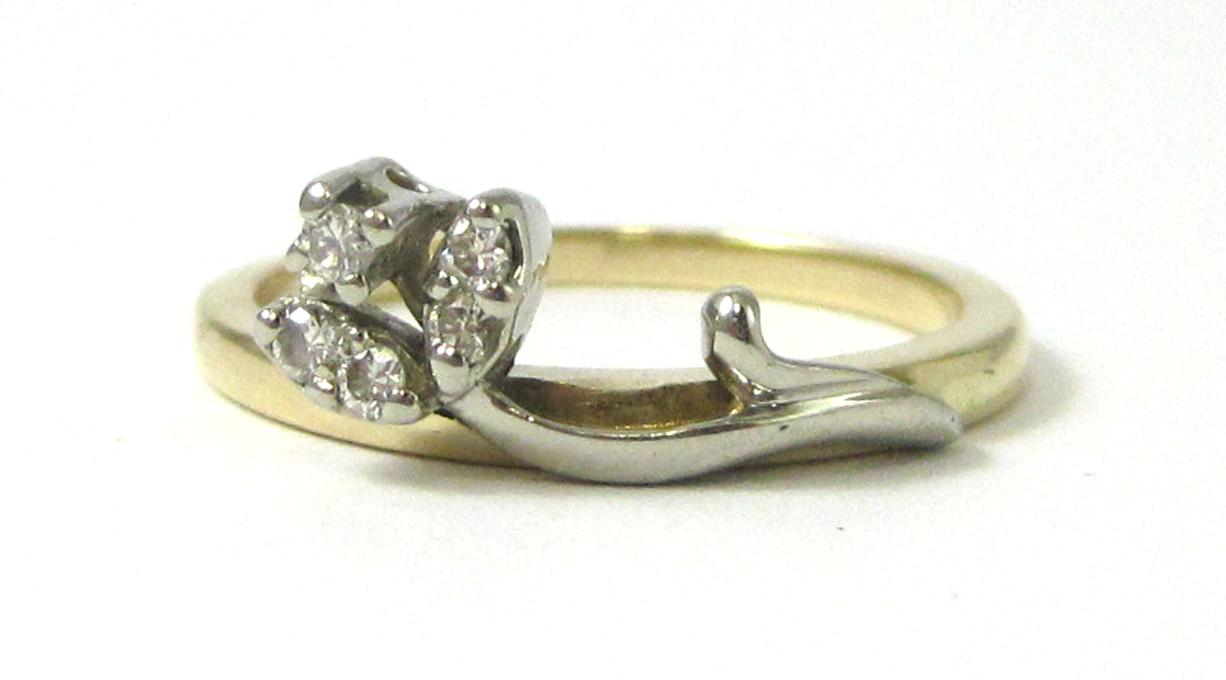 DIAMOND AND FOURTEEN KARAT GOLD RING set with five round