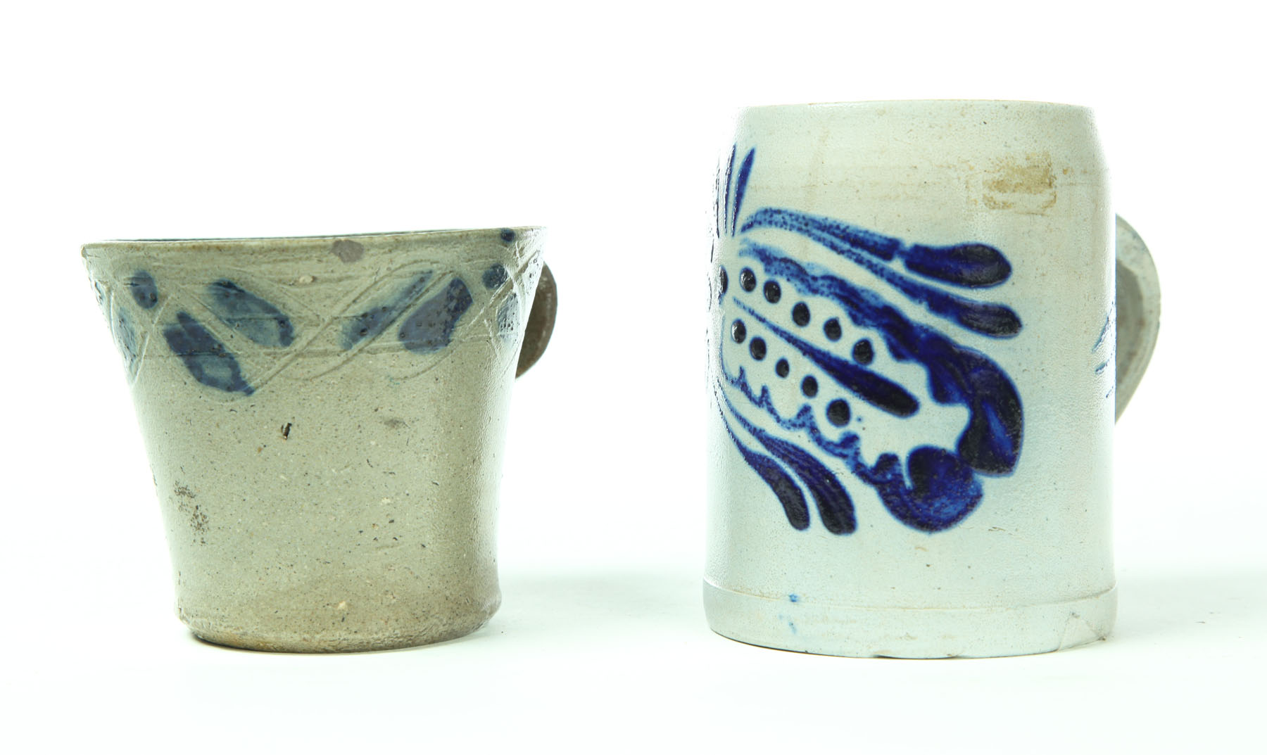 TWO STONEWARE MUGS American 2nd half 19th century Earlier one