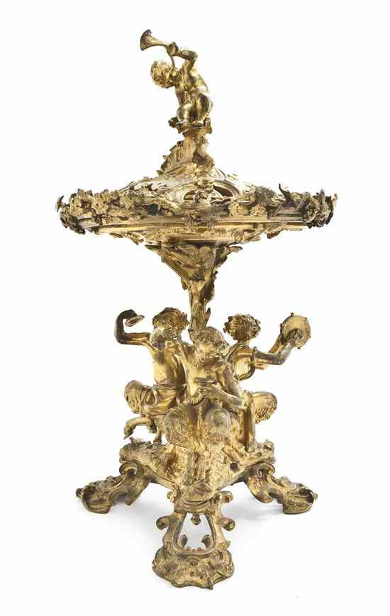 A French Gilt Bronze Figural Plate Rack the cover with
