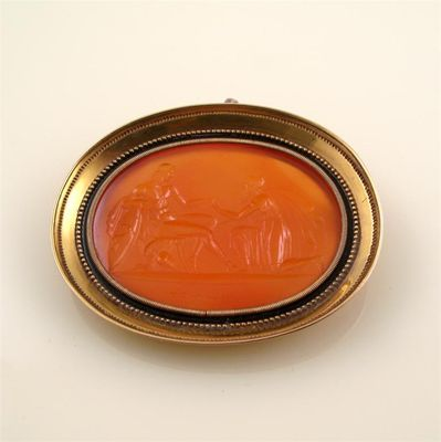 A large intaglio brooch The well carved cornelian oval section