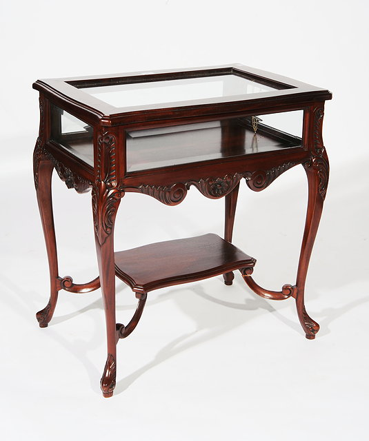 A MAHOGANY BIJOUTERIE TABLE glass door top on carved cabriole