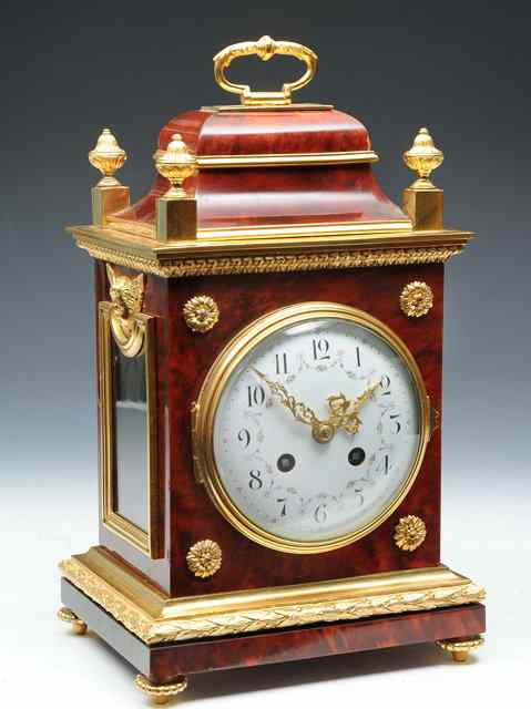 A TORTOISESHELL AND GILT BRASS MOUNTED MANTEL CLOCK the convex