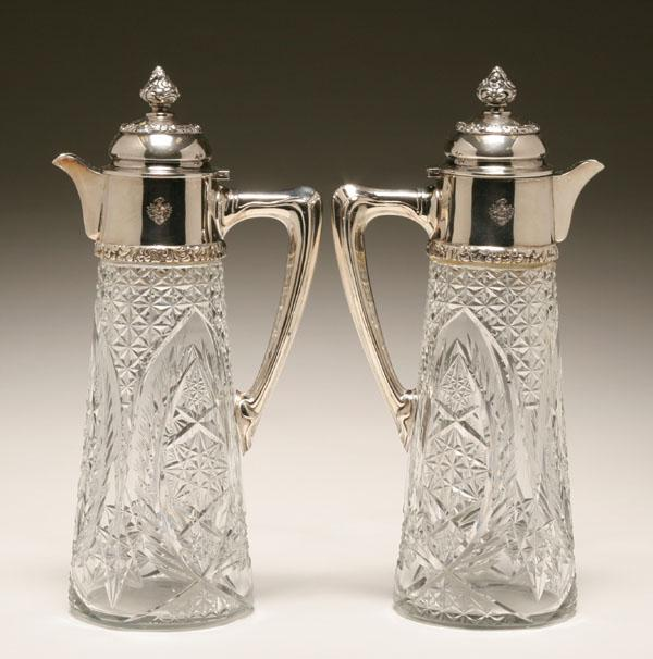 A pair of Austro Hungarian silver claret jugs wheel cut
