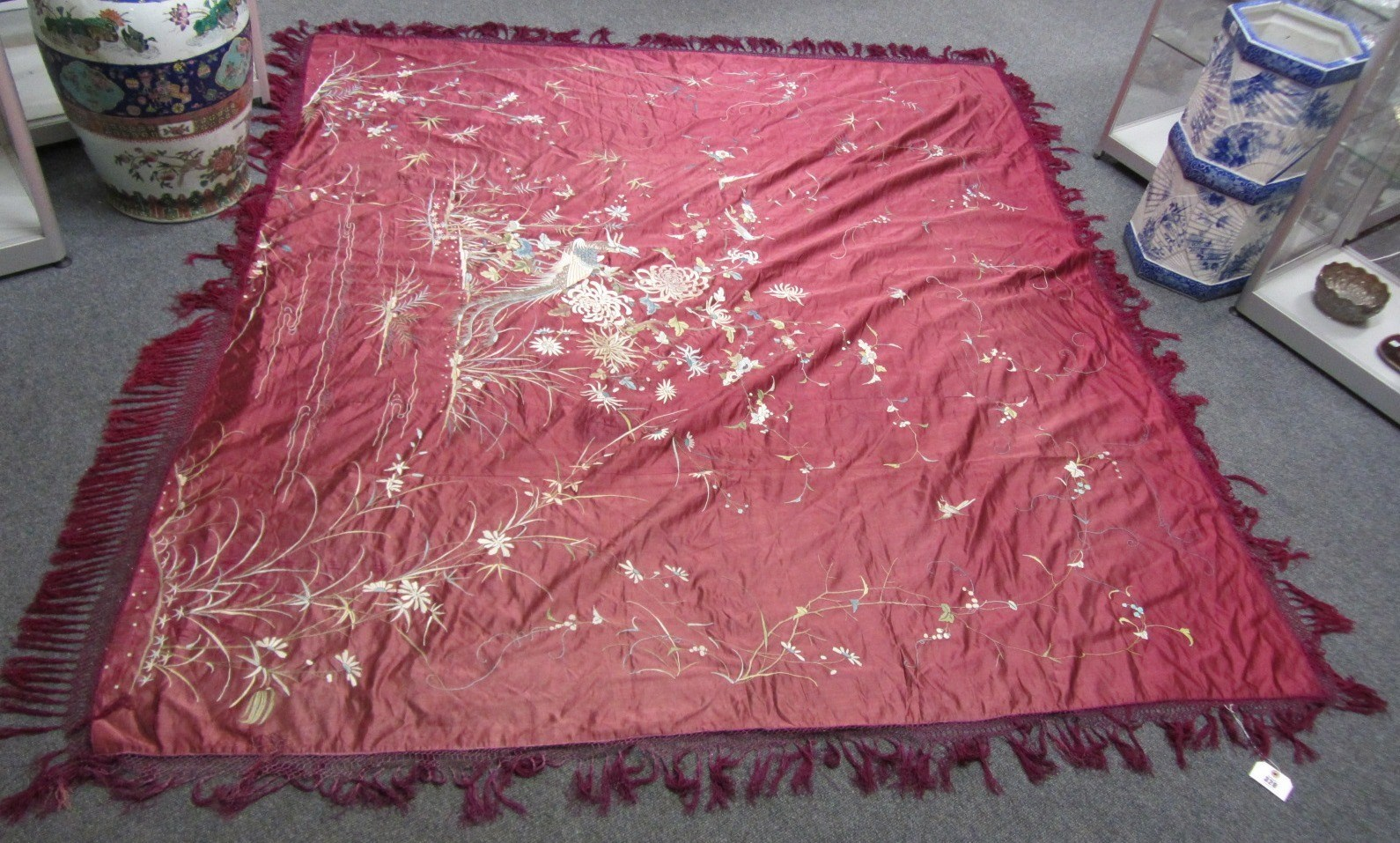 A Canton burgundy ground silk coverlet in a black gilt