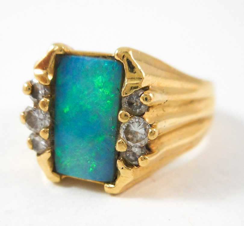 OPAL DIAMOND AND FOURTEEN KARAT GOLD RING with three round