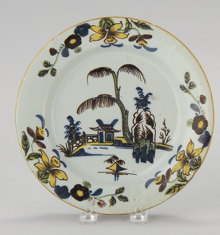 DELFT POLYCHROME POTTERY PLATE Circa 1720With central Oriental landscape with