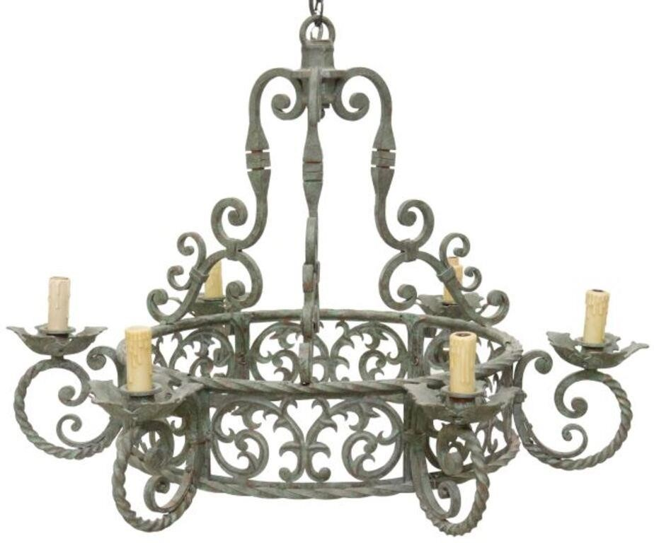 Wrought iron six light chandelier in a verde patina having