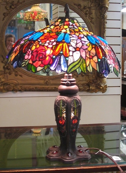 A TIFFANY STYLE TABLE LAMP The curved panel stained and