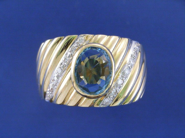 An 18ct gold blue topaz and 14 diamond set dress