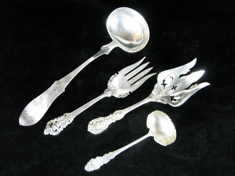 Four Sterling Silver Serving Pieces the first a large pierced