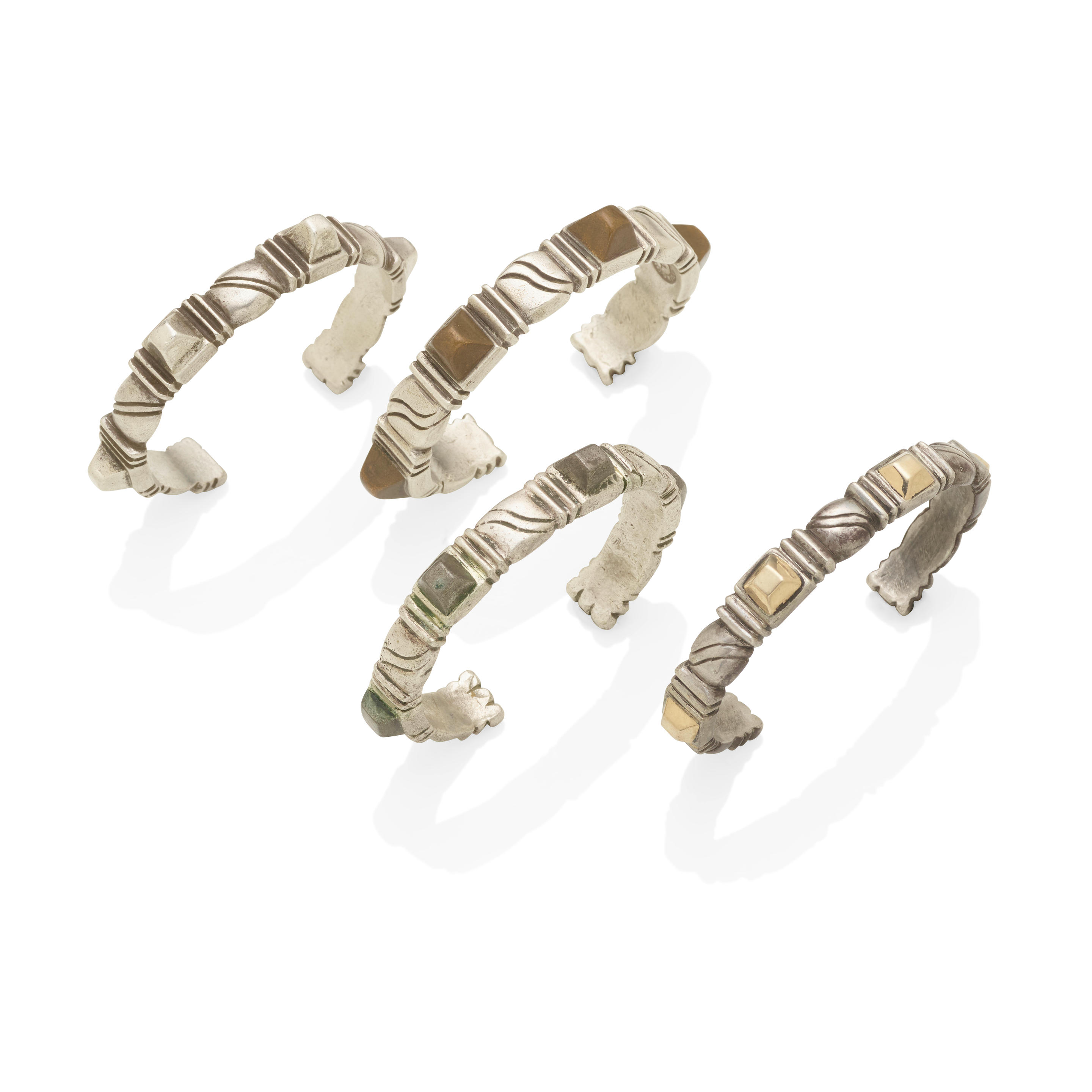 A SET OF FOUR SILVER AND MIXED METAL CUFFS WILLIAM
