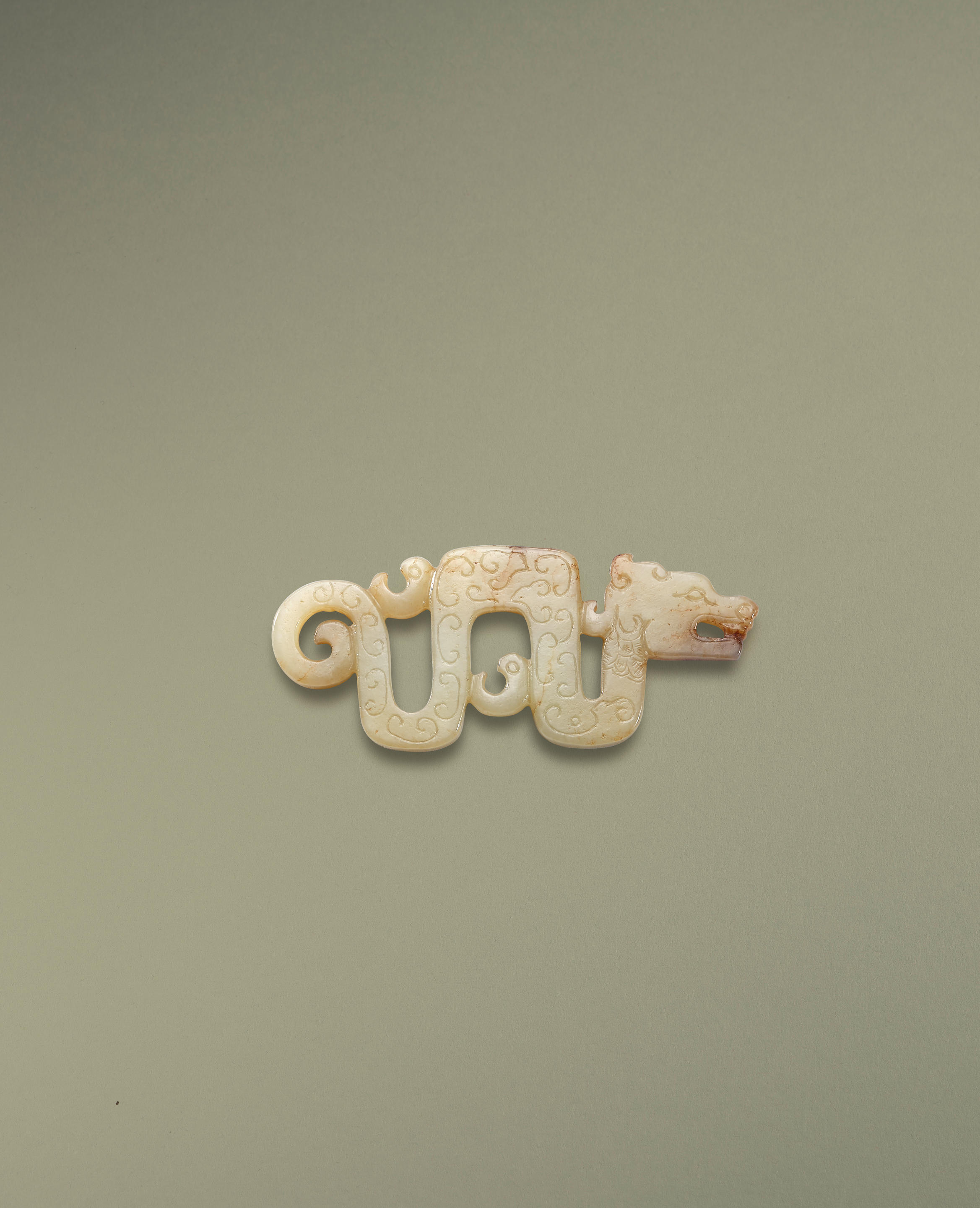 A SMALL WHITE JADE RETICULATED DRAGON PENDANT Song Dynasty Finely