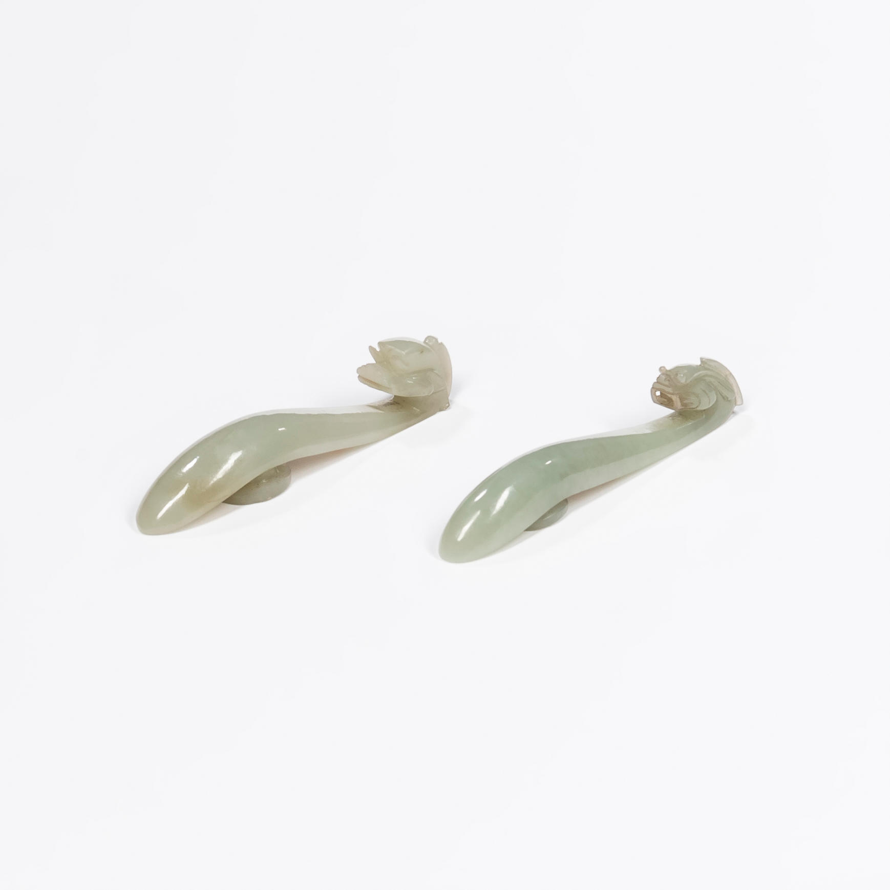 TWO CELADON JADE BELT HOOKS China serpentine dragon form hooks